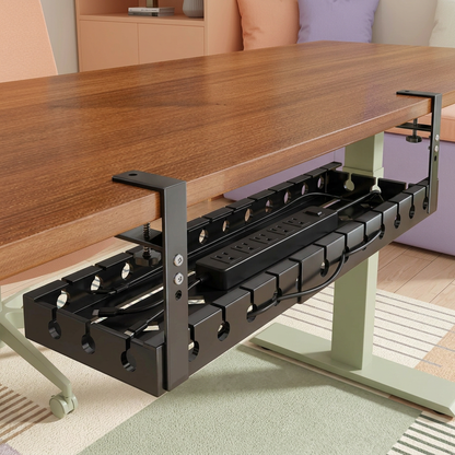 Black tray mounted beneath a wood desk with example cables and power strip